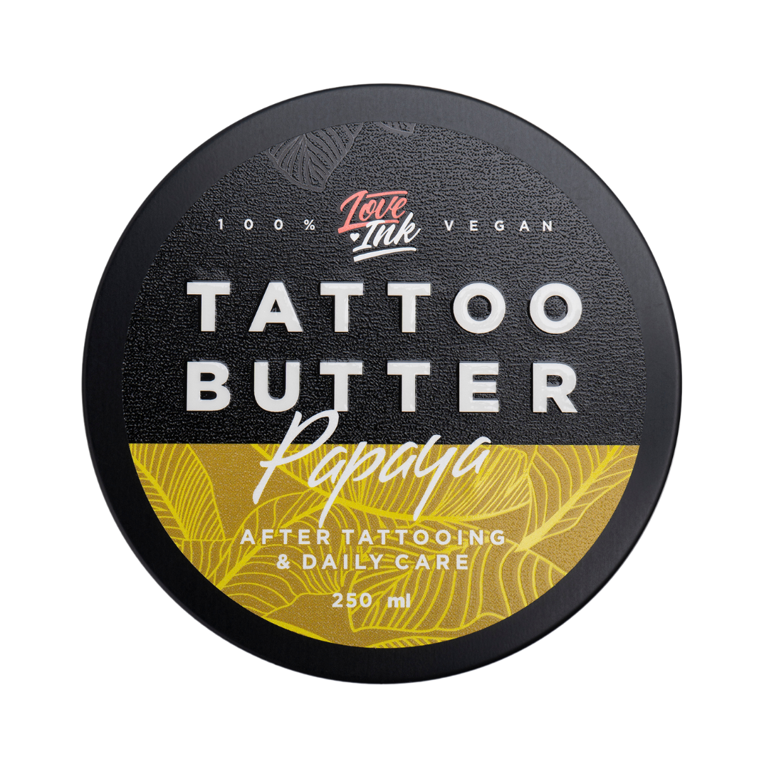 Close-up of a 250ml jar of Tattoo Butter Papaya by LoveInk. The product features a black and yellow design, emphasizing its use for after tattooing and daily care.