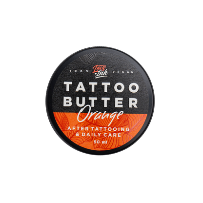 Top view of a 50ml jar of Tattoo Butter Orange by LoveInk. The sleek black and orange packaging highlights its purpose for after tattooing and daily care.