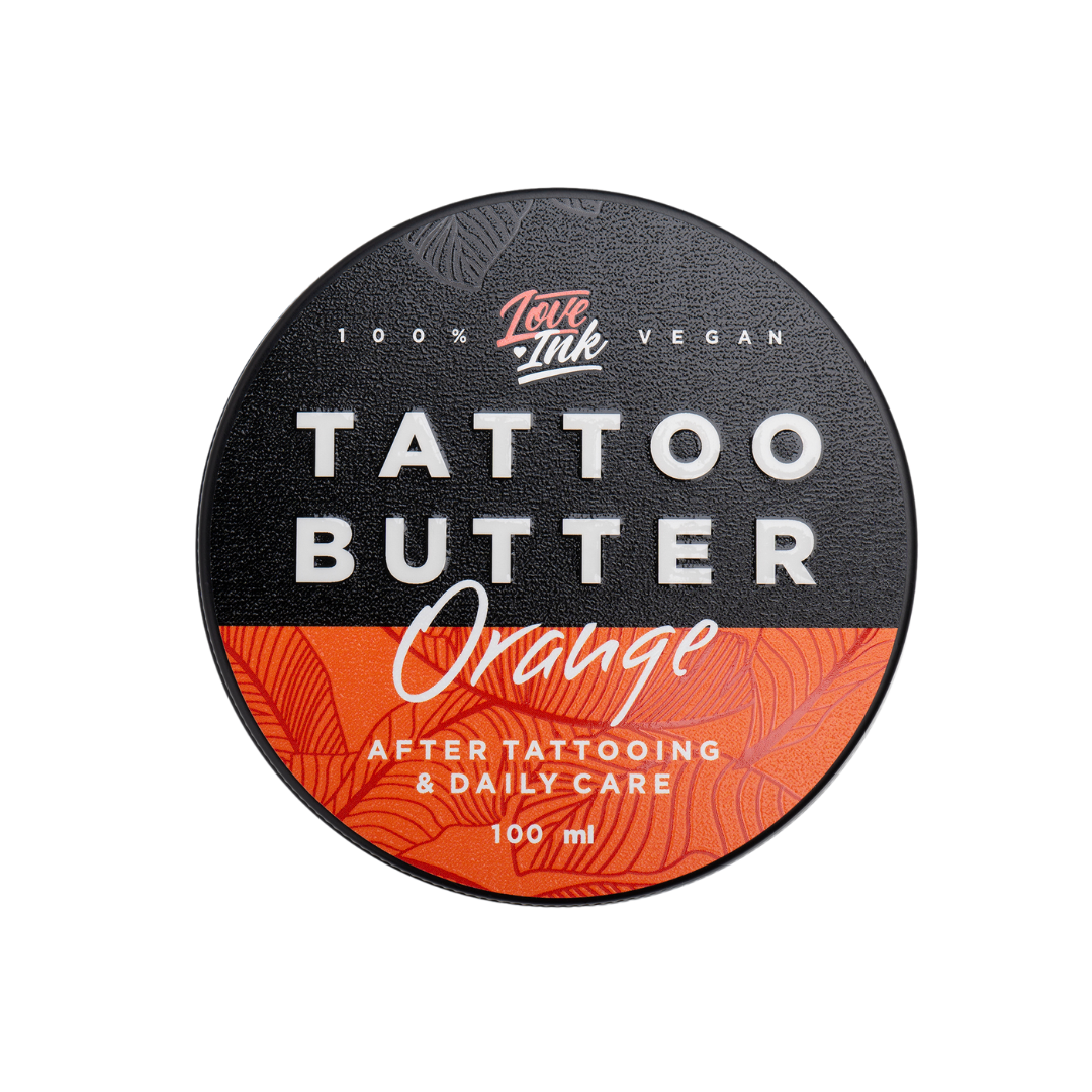 Close-up of a jar of Tattoo Butter Orange by LoveInk. The sleek black and orange packaging highlights its purpose for after tattooing and daily care, 100ml size.